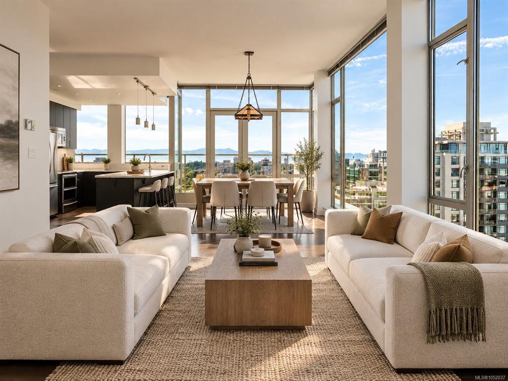 Bright condo living room with ocean and mountain views