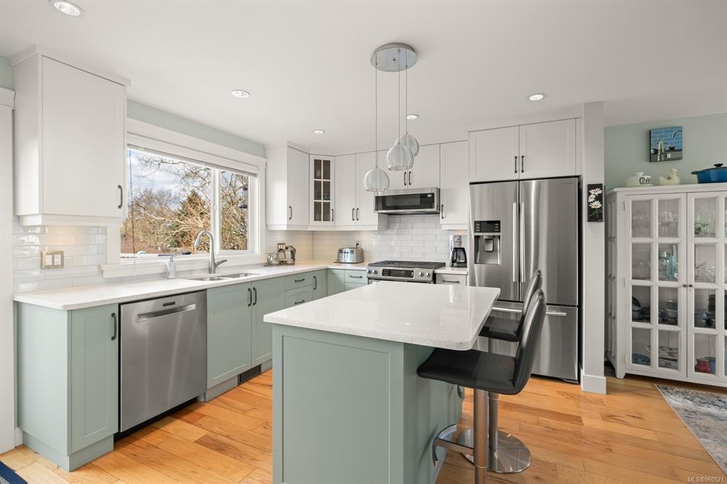 Bright kitchen with sage green cabinets, ready for listing photos